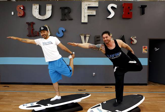 Co-owners Jason Laricchia, left, and Jason Santiago demonstrate some moves on the boards at Surfset Fitness in Las Vegas on Monday, October 7, 2013.