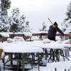 Manuel Franco cleans snow from chairs and tables on the patio of the Mt. Charleston Lodge on Mount Charleston Thursday, Oct. 10, 2013.