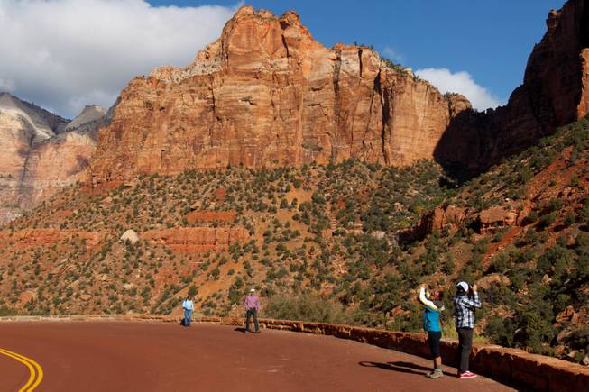 Visitors to Zion National Park take in the sights after the park opened on a limited basis Friday, Oct. 11, 2013, near Springdale, Utah.