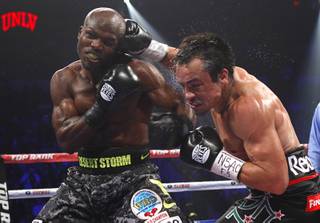 Undefeated WBO welterweight champion Timothy Bradley Jr., left, takes a punch from Juan Manuel Marquez of Mexico during their title fight at the Thomas & Mack Center Saturday, Oct. 12, 2013.