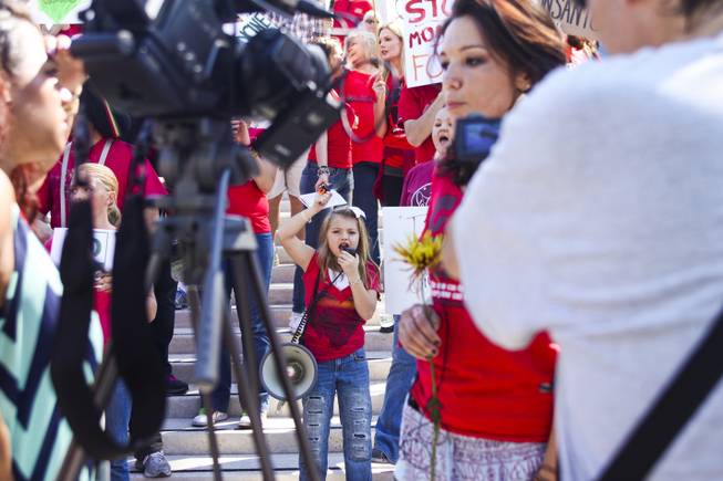 A little girl yells into a megaphone outside the U.S. district courthouse during the "March Against Monsanto" protest opposing genetically modified food in downtown Las Vegas, Saturday, Oct. 12, 2013.