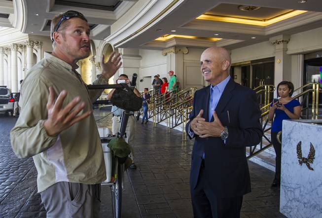 Gerald Tuthill, assistant general manager of Caesars Palace, greets “The Walking Man” Karl Bushby on Monday, Oct. 14, 2013, outside Caesars.

