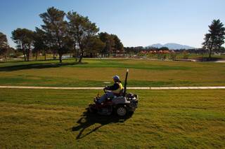 A worker mows some of the vast expanse of turf at the soon to open Craig Ranch Park in North Las Vegas Tuesday, October 15, 2013,