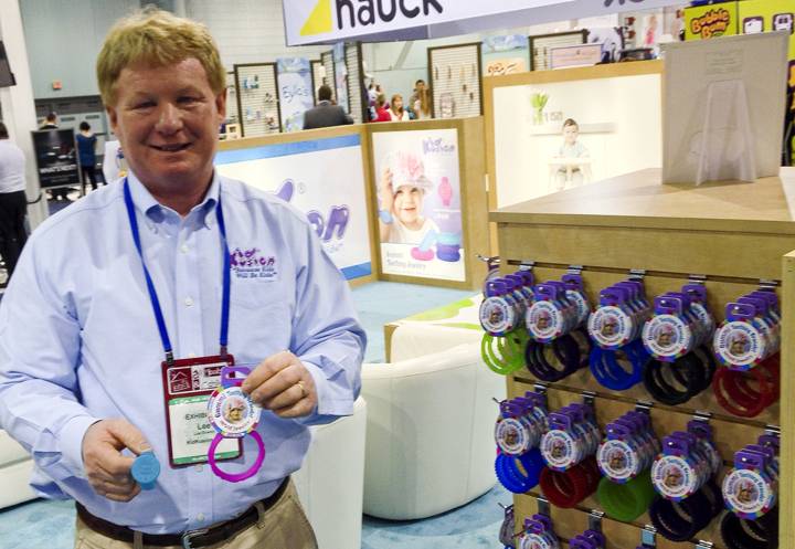 Lee Bowen, vice president of operations for Kid Kusion, holds up items from their Gummi teething jewelry line at the ABC Kids Expo at the Las Vegas Convention Center, Tuesday, Oct. 15, 2013.