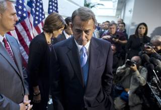 Speaker of the House Rep. John Boehner, R-Ohio, walks away from the microphone during a news conference after a House GOP meeting on Capitol Hill on Tuesday, Oct. 15, 2013 in Washington. The federal government remains partially shut down and faces a first-ever default between Oct. 17 and the end of the month.