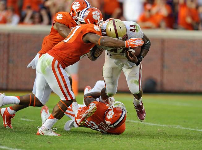 Clemson's Garry Peters (26), Robert Smith (27) and Vic Beasley stop Boston College's Andre Williams in the backfield during the second half of an NCAA college football game Saturday, Oct. 12, 2013, at Memorial Stadium in Clemson, S.C. Clemson won 24-14.