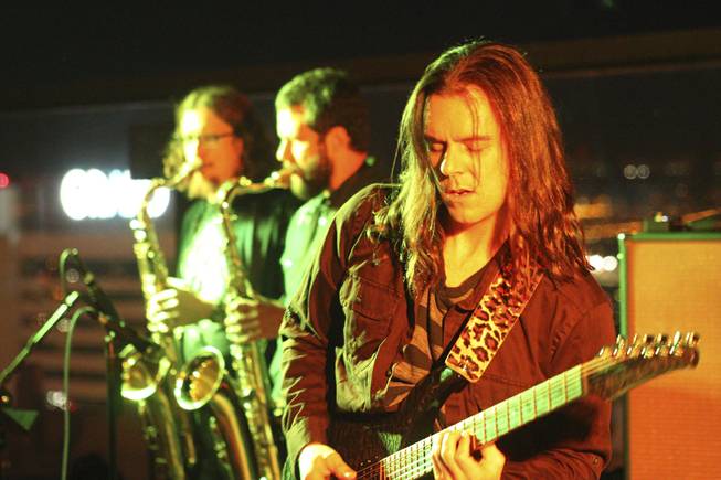 Guitarist Jeremy Parks, right, of local band Moksha during their set at the "Rooftop Fall Ball 3" on the Binion's Gambling Hall & Hotel rooftop pool deck, Friday, Oct. 18, 2013.