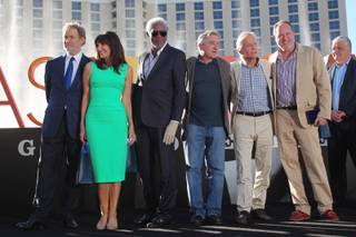 The cast of the film Last Vegas, from left, Kevin Kline, Mary Steenburgen, Morgan Freeman, Robert De Niro, Michael Douglas and director Jon Turteltaub, pose for photos after receiving honors from Las Vegas and Clark County Friday, Oct. 18, 2013 in front of the Bellagio.