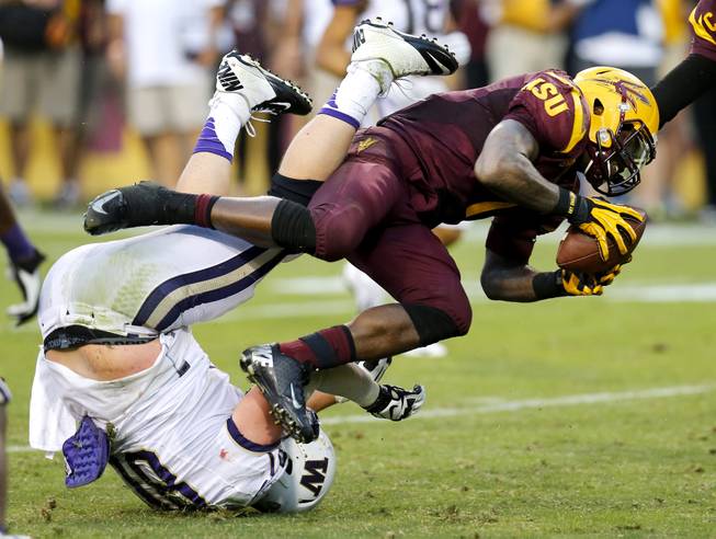 Arizona State running back Marion Grice (1) knocks over Washington defensive end Evan Hudson, left, during the second half of an NCAA college football game, Saturday, Oct. 19, 2013, in Tempe, Ariz. Arizona State won 53-24. 
