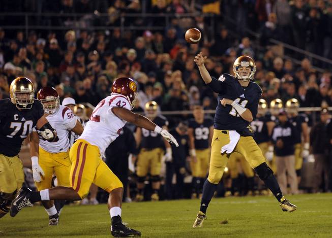 Notre Dame quarterback Tommy Rees throws a pass in a NCAA college football game with Southern California Saturday Oct. 19, 2013 in South Bend, Ind. 