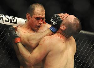 Former heavyweight champion Junior Dos Santos, left, and UFC heavyweight champion Cain Velasquez  fight for the UCF World Heavyweight title in Houston, Saturday, Oct. 19, 2013. Velasquez kept his title, beating Santos with a TKO in the fifth round. (AP Photo/Pat Sullivan)