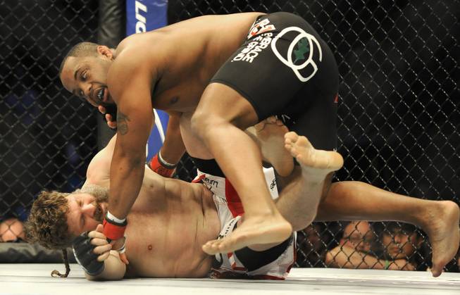 Daniel Cormier, top, wrestles Roy Nelson in a UFC heavyweight bout in Houston, Saturday, Oct. 19, 2013. Cormier won in a unanimous decision. (AP Photo/Pat Sullivan)
