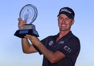 Webb Simpson of Charlotte, N.C. poses with his trophy after winning the Shriners Hospitals for Children Open at TPC Summerlin Sunday Oct. 20, 2013.