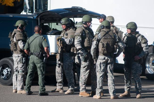 Swat team members secure the scene near Sparks Middle School in Sparks, Nev., after a shooting there on Monday, Oct. 21, 2013.  Authorities are reporting that two people were killed and two wounded at the Nevada middle school. 