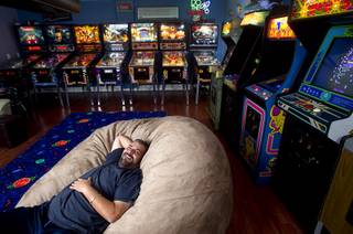 Pinball repairman Craig Snelling relaxes in the game room of his Henderson home Tuesday, Oct. 22, 2013. Snelling is a pinball machine repairman and owner of Billiards 'N More, a billiards and game room supply store.