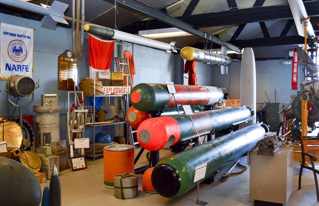 A stack of naval torpedos sits in the Hawthorne Ordnance Museum, Wednesday, Oct. 23, 2013.. Behind them is a 1960s era drone that was designed to hunt enemy submarines.