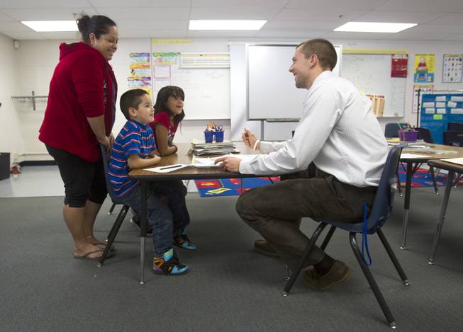 First grade teacher Charlie Lockwood talks with his student Angel Rosales, his mother Fabiola and his sister Marisol during a parent-teacher conference at Lois Craig Elementary School in North Las Vegas Wednesday, Oct. 23, 2013. 