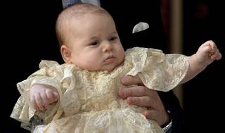 Britain's Prince George is held by his father Prince William as they arrive at Chapel Royal in St James's Palace in London, for the christening of the three month-old Prince Wednesday Oct. 23, 2013.