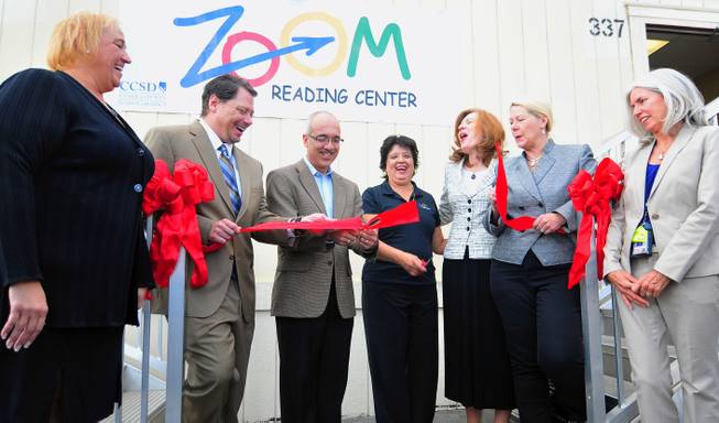 Nevada Senate Majority Leader Mo Denis cuts a ribbon to a "Zoom" Reading Center on Wednesday, October 23, 2013, at Lunt Elementary School. From left to right: Clark County Schools Superintendent Pat Skorkowsky, Lunt Principal Thelma Davis, Academic Manager Danielle Miller, UNLV law professor Sylvia Lazos, School Board members Lorraine Alderman and Patrice Tew and State Senator Mo Denis.