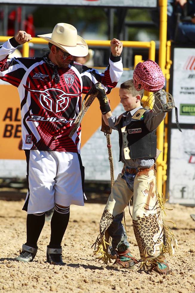 Entertainer Matt Merritt of Olin, N.C. dances with Thumper Meadows, 11, during the Chris Shivers Miniature Bull Riding (MBR) World Finals at Mandalay Bay Thursday, Oct. 24, 2013. The MBR features junior riders ages 8 to11 and senior riders ages 12 to 14. The event was part of the the 2013 Professional Bull Riders Built Ford Tough World Finals.