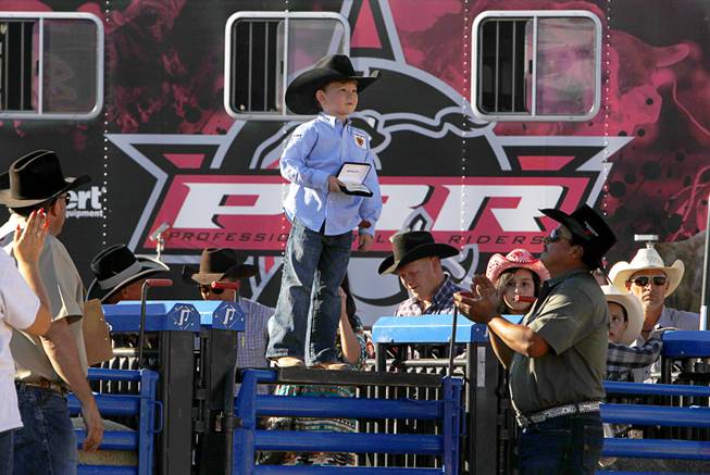 Blayne Shivers, 6, of Jonesville, La., son of professional bull rider Chris Shivers, poses with his championship buckle after winning the afternoon Mutton Bustin" competition at the Tyson Fan Zone & marketplace at Mandalay Bay Thursday, Oct. 24, 2013. The event was part of the the 2013 Professional Bull Riders Built Ford Tough World Finals.