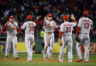 The St. Louis Cardinals celebrate after defeating the Boston Red Sox, 4-2, in Game 2 of baseball's World Series Thursday, Oct. 24, 2013, in Boston. The series is at 1-1. (AP Photo/Matt Slocum)