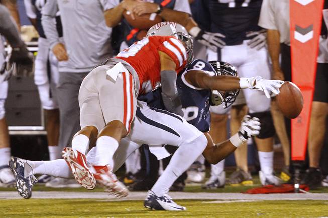 On fourth down and with time running out, UNR wide receiver Jerico Richardson can't pull in a pass while being covered by UNLV defensive bak Tajh Hasson during their game Saturday, Oct. 26, 2013 at Mackay Stadium in Reno. UNLV defeated UNR 27-22 to reclaim the Fremont Cannon.