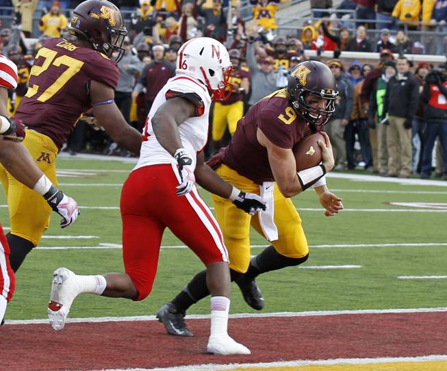 Minnesota quarterback Philip Nelson (9) carries the ball into the end zone for a touchdown during the fourth quarter of an NCAA college football game against Nebraska in Minneapolis Saturday, Oct. 26, 2013. Minnesota beat Nebraska 34-23. 