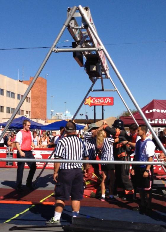 A referee high-fives Jackie Palmer after she completed the Firefighter Combat Challenge on on Saturday, Oct. 26, 2013.
