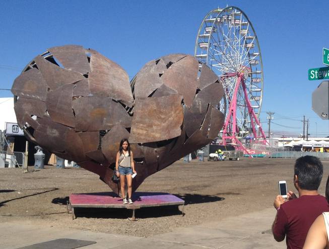 Minutes after the gates opened, people lined up for photos in front of this massive sculpture of a heart, the symbol of the Life is Beautiful festival, Saturday, Oct. 26, 2013.