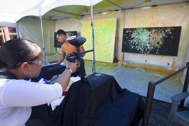 Gayland (no last name given) uses a paintball gun to make art during the Life is Beautiful Festival in downtown Las Vegas Sunday, Oct. 27, 2012.