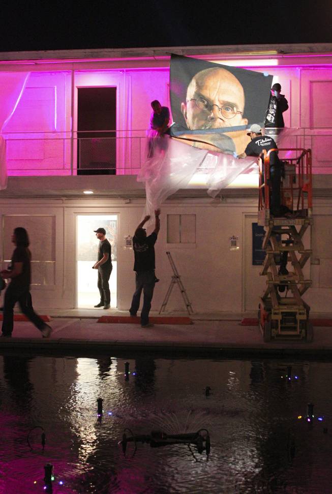 The Chuck Close tapestry at the 'Art Odyssey' is taken down on the closing of the Life Is Beautiful Festival, Sunday, Oct. 27, 2013.