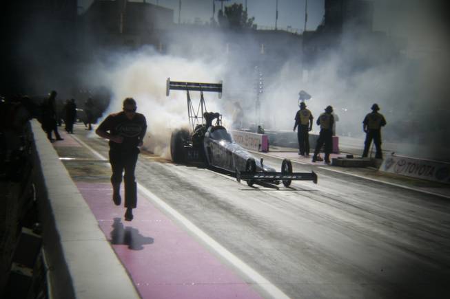 Khalid alBalooshi smokes his tires during the Mello Yello Drag Racing Series Toyota Nationals at The Strip at the Las Vegas Motor Speedway Saturday, Oct. 27, 2013. Photo was shot with a plastic toy lens.