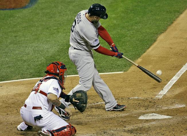 Boston Red Sox's David Ross hits an RBI double during the seventh inning of Game 5 of baseball's World Series against the St. Louis Cardinals Monday, Oct. 28, 2013, in St. Louis.