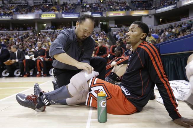 Chicago Bulls guard Derrick Rose gets his knees iced on the bench in the second half of an NBA preseason basketball game against the Indiana Pacers in Indianapolis, Saturday, Oct. 5, 2013. The Bulls defeated the Pacers 82-76.