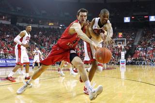 UNLV forward Christian Wood and Dixie State center Zach Robbins chase a ball during the Rebels exhibition game Friday, Nov. 1, 2013 at the Thomas & Mack Center.