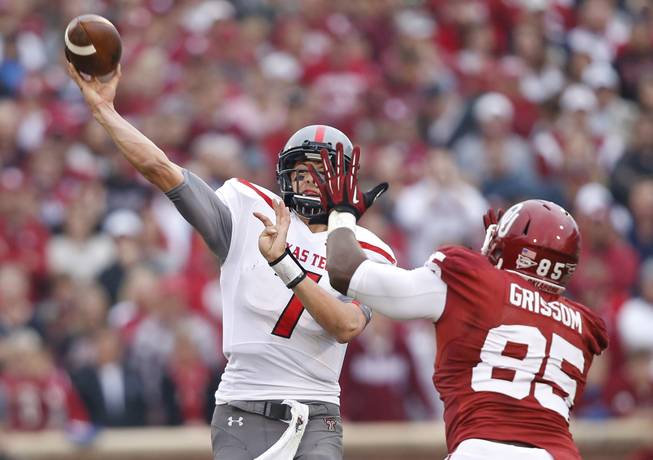 Texas Tech quarterback Davis Webb (7) passes under pressure from Oklahoma defensive end Geneo Grissom (85) in the first quarter of an NCAA college football game in Norman, Okla., Saturday, Oct. 26, 2013. Oklahoma won 38-30.