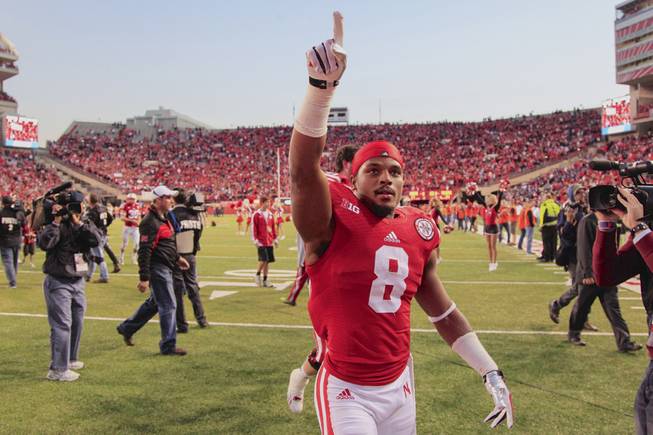 Nebraska running back Ameer Abdullah (8) gestures to fans in the stands following an NCAA college football game against Northwestern in Lincoln, Neb., Saturday, Nov. 2, 2013. Nebraska won 27-24. 