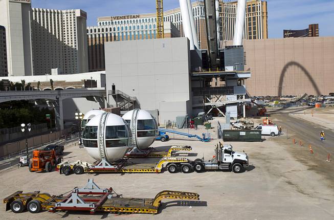 Cabins (L) are shown next to the 550-foot tall High Roller, the world's tallest observation wheel, under construction near the Las Vegas Strip and Flamingo Road Thursday, Nov. 7, 2013. The wheel is the centerpiece of the Linq project, a $550 million outdoor retail, dining and entertainment district being developed by Caesars Entertainment Corp. The High Roller will feature 28 cabins that will each hold 40 passengers.
