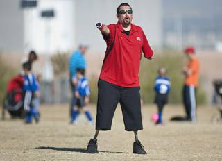 Youth soccer coach Eddie Garcia coaches his team from the sidelines during a game at Reunion Trails Park in Henderson on Saturday morning.