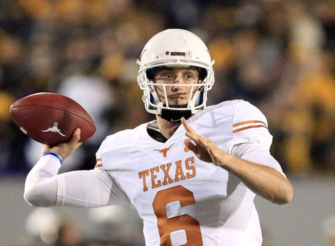 Texas quarterback Case McCoy finds an open receiver late in the fourth quarter during an NCAA college football game against Texas in Morgantown, W.Va., on Saturday, Nov. 9, 2013. Texas won 47-40 in overtime.