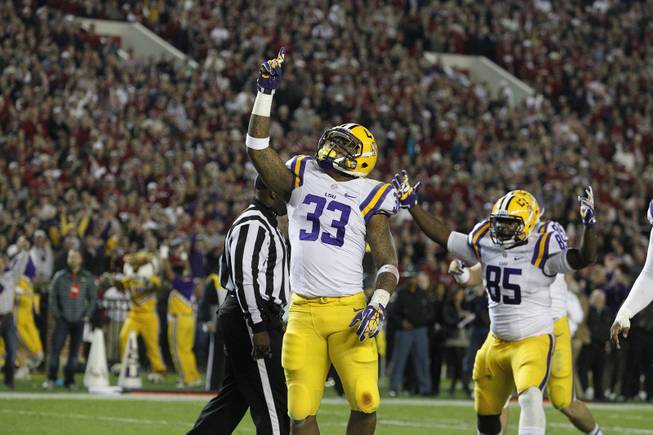 LSU running back Jeremy Hill (33) celebrates his touchdown against Alabama during the first half of an NCAA college football game, Saturday, Nov. 9, 2013, in Tuscaloosa, Ala. 