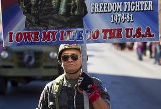 Sothy Seang, owner of the Donut Hut, marches in the Veterans Day parade in downtown Las Vegas Monday, Nov. 11, 2013. Seang fought with the Cambodian army against the Viet Cong during the Vietnam War.