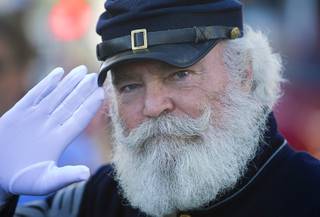 Civil War reenactor Jim Edwards salutes during the annual Veterans Day parade in downtown Las Vegas Monday, Nov. 11, 2013.