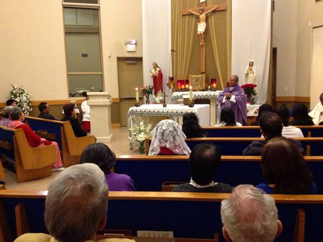 The Rev. Jesse Cortes delivers his homily Monday night at St. Bridget Catholic Church in downtown Las Vegas. About 60 parishioners, many originally from the Philippines, gathered in the church's adoration chapel to pray for those affected by the super-typhoon that struck the Philippines last week. 