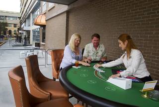 Angela And Tom Salestrom of Sioux Falls, S.D. are the first to try out the outdoor blackjack tables on Third Street following an official opening ceremony for the Downtown Grand in downtown Las Vegas Tuesday, Nov. 12, 2013.
