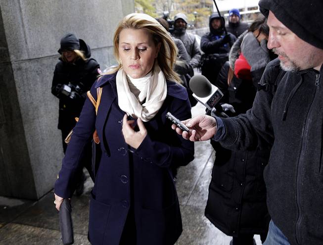 Genevieve Sabourin, who is charged with stalking actor Alec Baldwin, speaks with reporters as she arrives for her trial at criminal court Tuesday, Nov. 12, 2013, in New York. 
