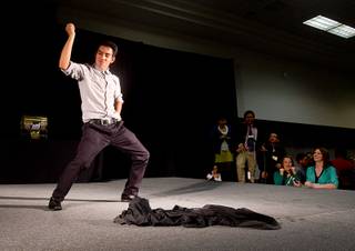 Student Giovanny Vasquez of Western High School dances on stage during a lunch break at the annual Las Vegas Sun Youth Forum in the Las Vegas Convention Center Wednesday, Nov. 13, 2013.