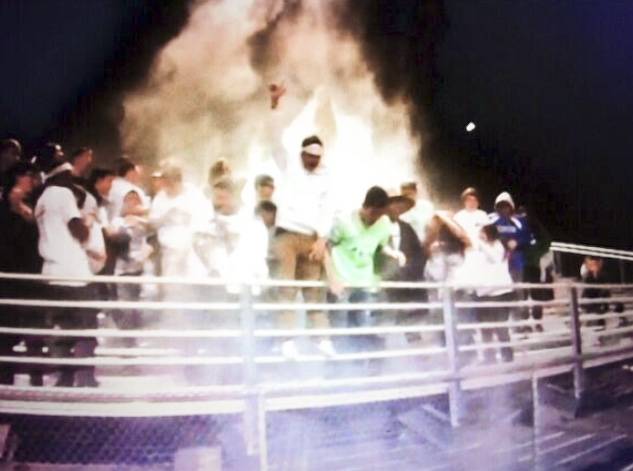 Members of the Green Valley High School Instigators throw flour, talcum powder and glitter in the air during the football team's game against Foothill last week. Several students were suspended for the act.