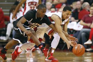 Omaha guard C.J. Carter and UNLV guard Kendall Smith chase a loose ball during their game Friday, Nov. 15, 2013 at the Thomas & Mack Center.